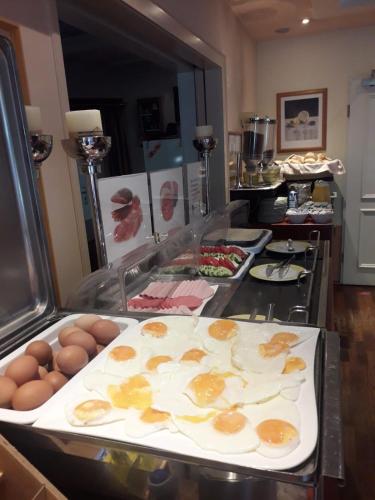 a kitchen with eggs and other foods on a counter at HOTEL S Norderstedt in Norderstedt