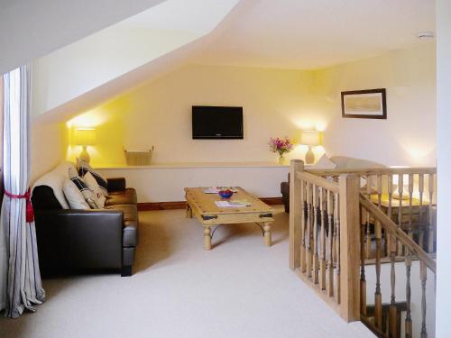 a living room with a couch and a table at Bramble in Hartland