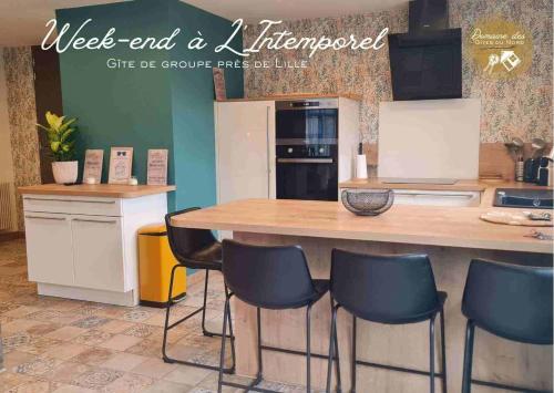 a kitchen with a large wooden table and chairs at Domaine des Gites du Nord - L'Intemporel - 4 à 5 chambres entre Lille, Arras et La Belgique in Chemy