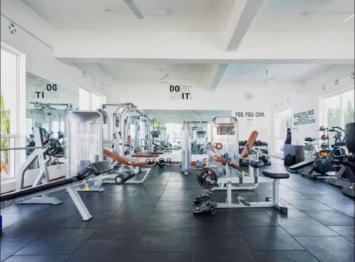 a gym with several treadmills and machines in a room at Alvy 2bedroom apartment in Mombasa