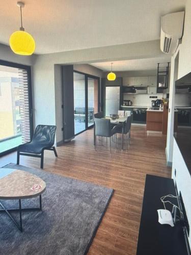 a living room with a dining room and a kitchen at Cyprus Sunbay Retreat in Ayia Napa