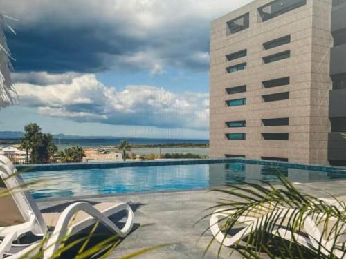 a hotel swimming pool with a view of a building at Cyprus Sunbay Retreat in Ayia Napa