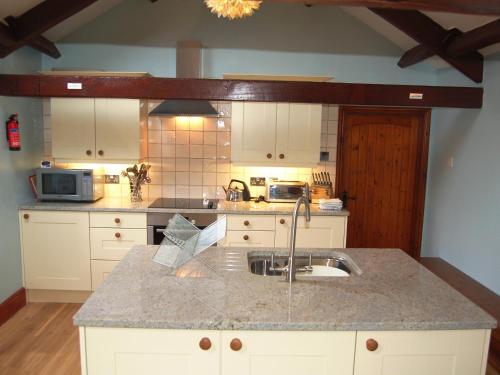 a kitchen with a sink and a counter top at Gill Barn in Bampton