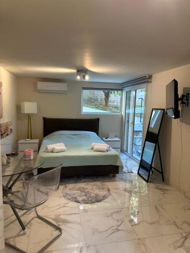 a bedroom with a bed and a glass table at JOHNMAR apartment in Athens