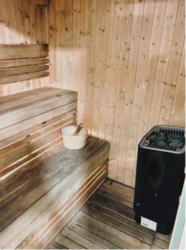 a sauna with a stove and a bucket in it at Luxury Jr. 1BR in Mayan Yas Island in Abu Dhabi