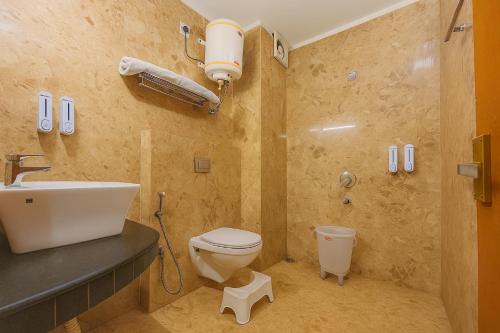 a bathroom with a toilet and a sink at The Kempty Emerald - A Wellness Boutique Hotel, Mussoorie in Mussoorie