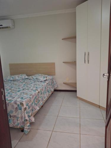 a bedroom with a bed and a tiled floor at Ocean View Tabatinga Residence in Barra de Tabatinga