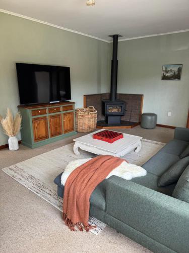 a living room with a couch and a tv at Riverslea on Farndon in Clive