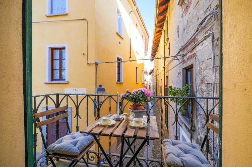 a balcony with a table and chairs on a street at Casa Sofia in Cannobio