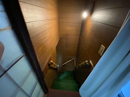 a stairway with green stairs in a room at 九州 福岡 貸切 プライベートハウス 