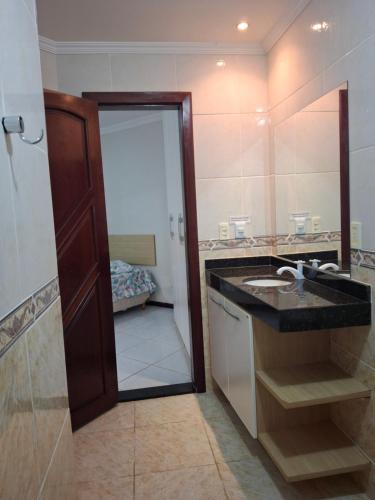 a bathroom with a sink and a mirror at Ocean View Tabatinga Residence in Barra de Tabatinga