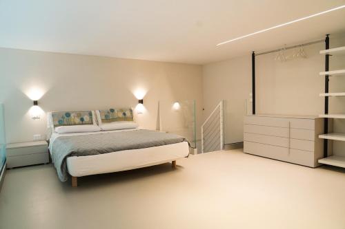 a bedroom with a bed and a dresser in it at Loft In Centro in Forlì