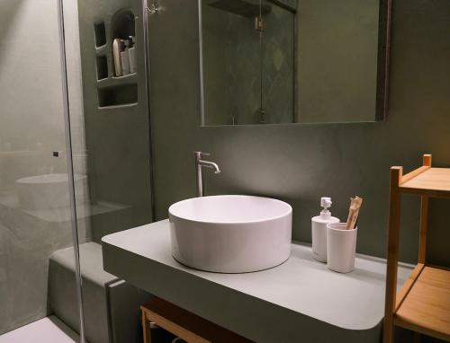 a bathroom with a white sink and a shower at Loft In Centro in Forlì