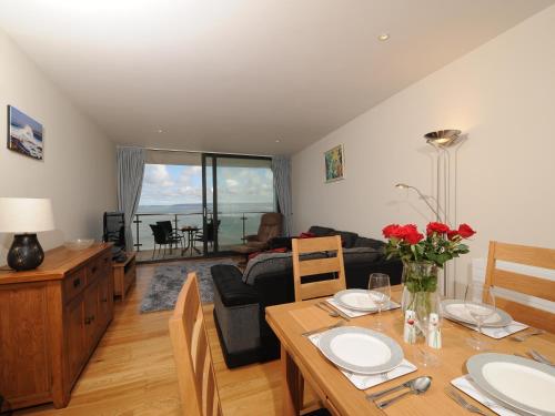 a living room with a dining table and a living room at Tidal Bay in Westward Ho
