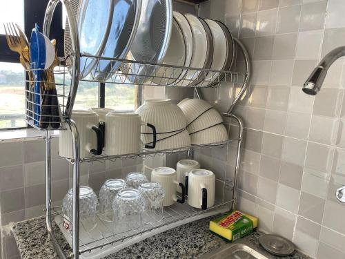 a shelf with plates and dishes on it in a kitchen at Calm getaway in Rongai in Ongata Rongai 