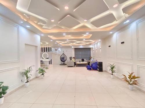 an office lobby with white tile floors and ceilings at Private room & attached washroom 102 , Zero mile in Patna