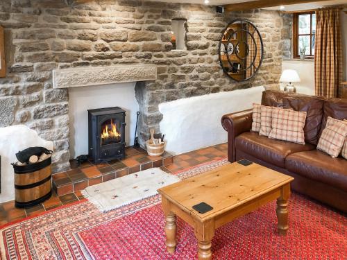 a living room with a couch and a fireplace at Cotton Cottage in Hope