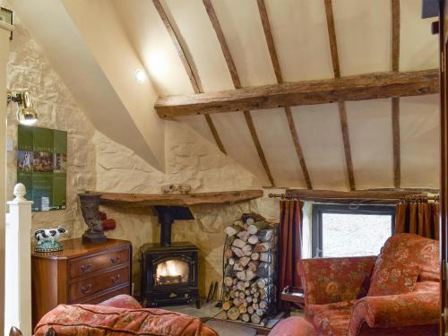 a living room with a wood stove in a room at The Hayloft - Igp in Glaisdale