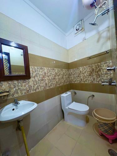 a bathroom with a toilet and a sink at Hotel the Chandigarh in Chandīgarh