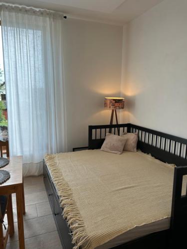 a bedroom with a large bed with a window at Dům mezi loukami in Sněžné