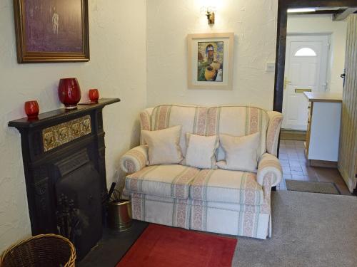 a living room with a couch with pillows on it at Hayrake in Ambleside