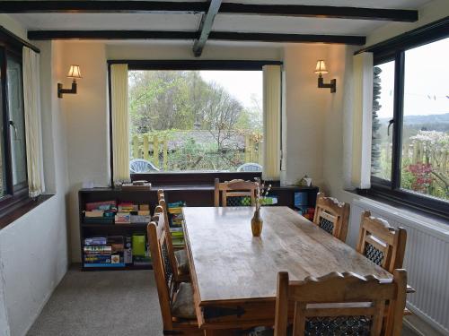 a dining room with a table and chairs and a window at Hayrake in Ambleside