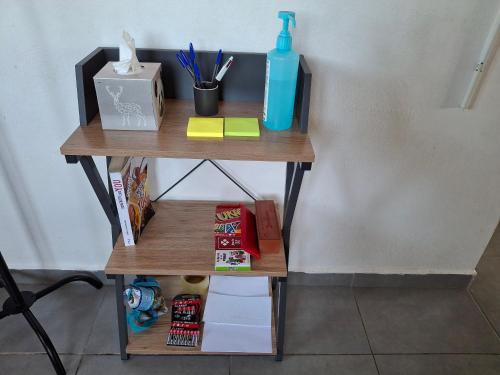 a small wooden table with a bottle of water on it at Haut de maison T4 à Petit Canal in Petit-Canal