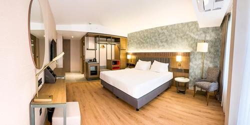 a bedroom with a large white bed in a room at Paşapark Selçuklu Hotel in Konya