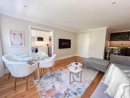 a living room with a couch and a table at Upscale Apartment in a Prestigious Area in London