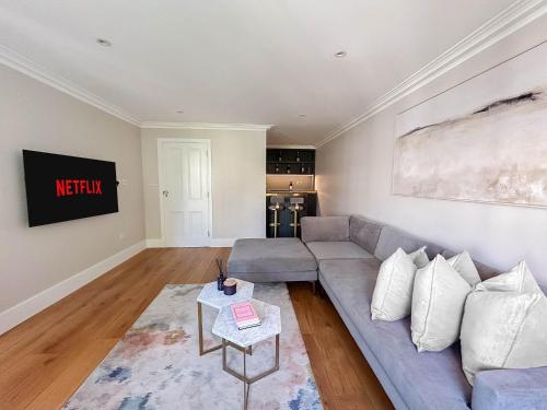 a living room with a couch and a table at Upscale Apartment in a Prestigious Area in London
