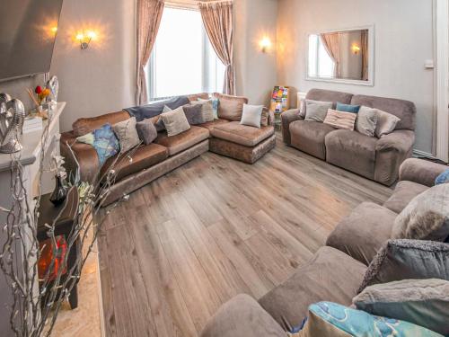 a living room with a couch and a table at The Ascot in Blackpool