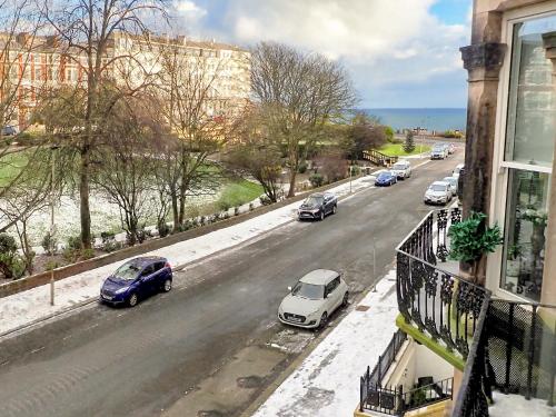 a view of a street with cars parked on the road at The Haven in Scarborough