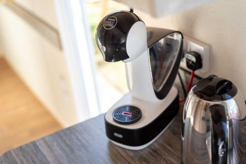 a juicer sitting on a counter next to a coffee pot at 3 Bedroom Caravan-Seton Sands in Port Seton