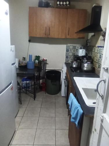 a kitchen with a sink and a stove top oven at Romantic Guest Rooms in London