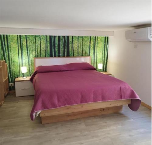 a bedroom with a large bed with a purple bedspread at Matī Guest House in Latiano