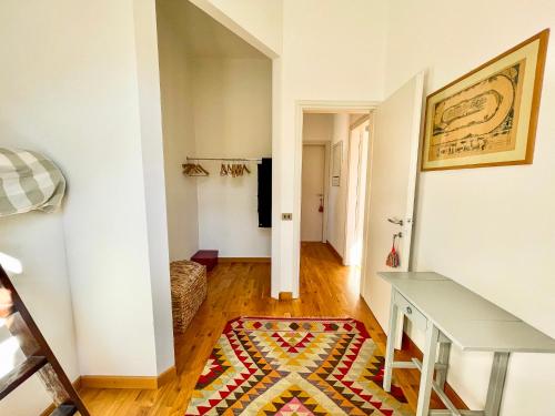 a hallway with a table and a rug at Casa Tranquilla in Cannobio