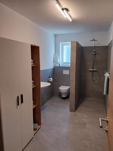 a bathroom with a toilet and a tub and a sink at Ferienwohnung Büchele in Umhausen