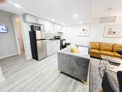 ブラントフォードにあるFriendly Garden Ave Suite 1 Mins to Hwy 403のソファとキッチンのあるリビングルーム
