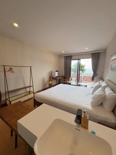 a hotel room with a large bed and a sink at Aya Beach Resort Koh Lipe in Ko Lipe