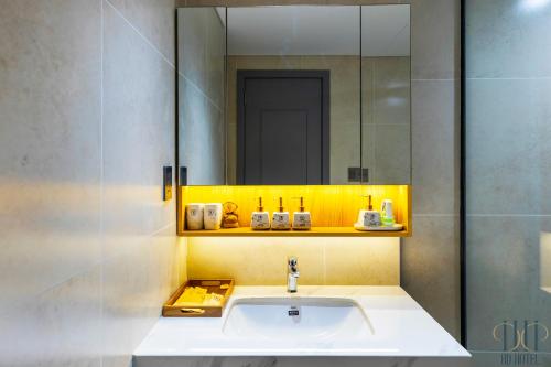 フーコックにあるHD Hotel Sunset Townの洗面台と鏡のあるバスルーム