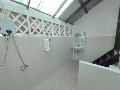 a bathroom with a toilet and a sink at Wooden House On The Bay in Ban Bang Chak