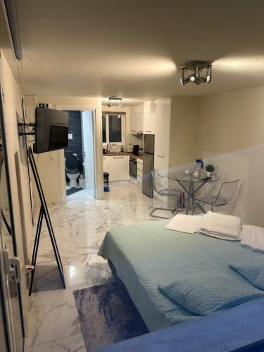a bedroom with a bed and a kitchen and a table at JOHNMAR apartment in Athens