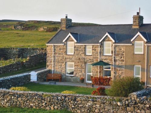 a stone house with a stone wall at Rhiwgoch - Hw7449 in Harlech