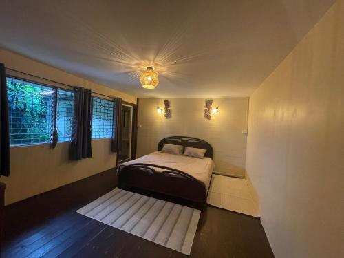 a small bedroom with a bed and a window at Fisherman's house on stilts Phuket Old Town in Ban Tha Khreng