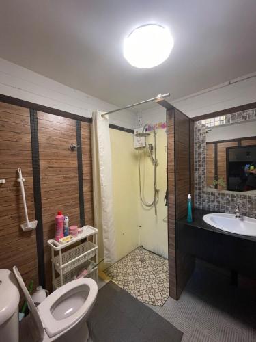 a bathroom with a toilet and a sink and a shower at Fisherman's house on stilts Phuket Old Town in Ban Tha Khreng