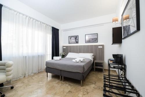 a bedroom with a bed with two towels on it at Talìa Rooms And Gallery in Messina