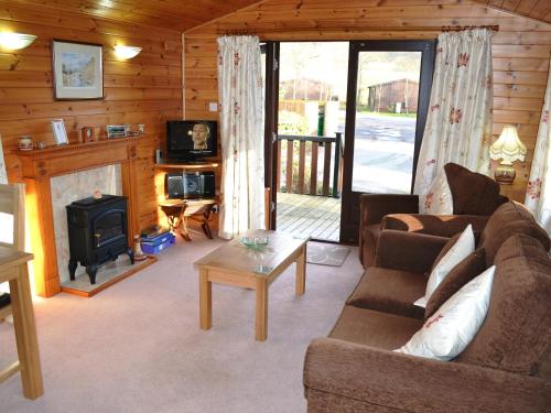 a living room with a couch and a stove at Ashness in Keswick