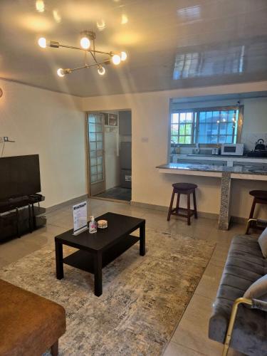 a living room with a couch and a table at Palm and Pillow in Freetown