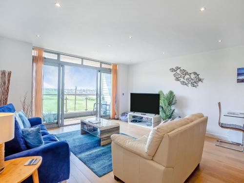 a living room with a couch and a television at 7 Cribbar in Newquay