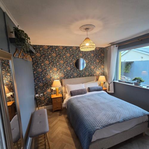 a bedroom with a bed with a blue comforter at Salmon island view in Dromineer